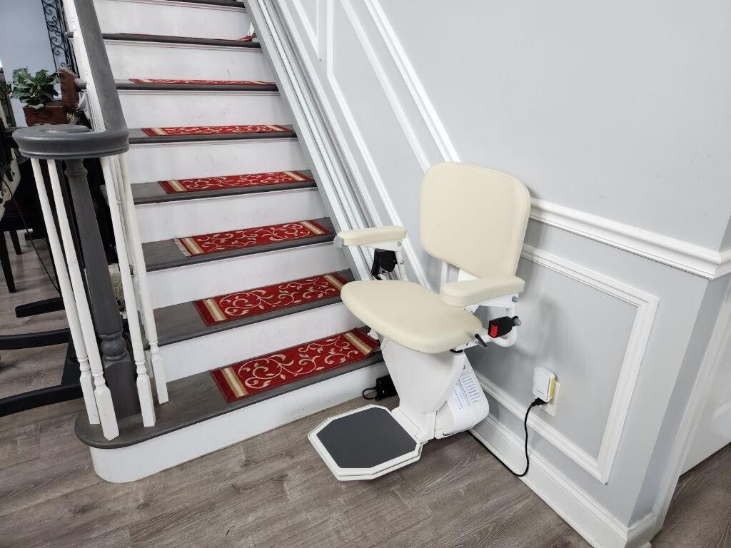 AmeriGlide stairlift installed on a staircase with patterned stair runners